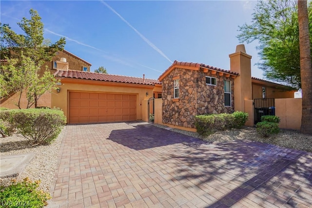 mediterranean / spanish house with a garage