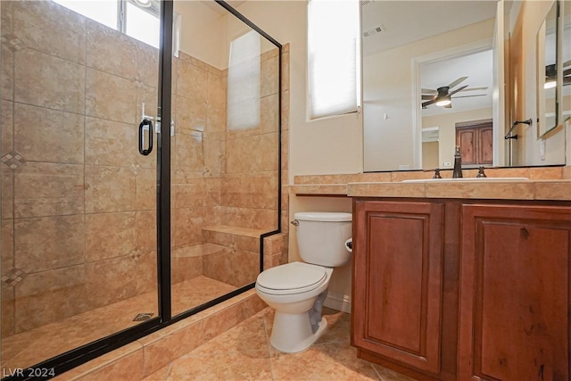 bathroom featuring ceiling fan, tile patterned flooring, vanity, an enclosed shower, and toilet