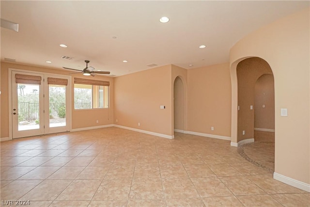 tiled spare room featuring ceiling fan