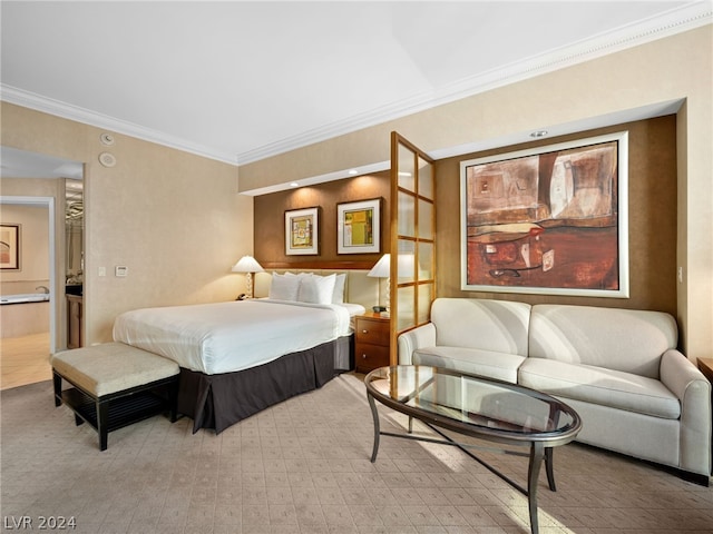 bedroom with crown molding and ensuite bath