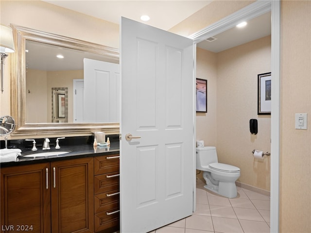 bathroom featuring toilet, vanity, and tile patterned flooring