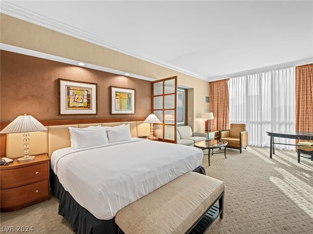 bedroom with ornamental molding and light colored carpet