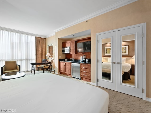 carpeted bedroom with french doors, ornamental molding, and a closet