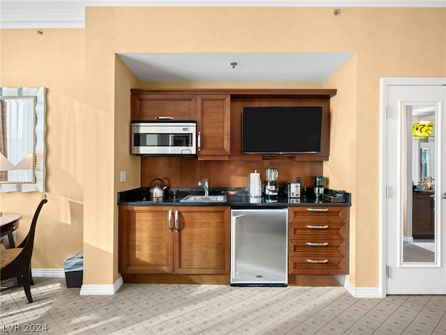 kitchen with sink, crown molding, and stainless steel appliances