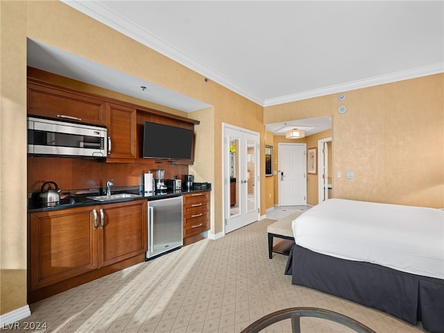 bedroom with sink, crown molding, and french doors