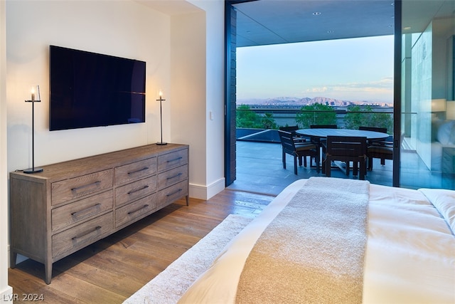 bedroom with hardwood / wood-style flooring and floor to ceiling windows