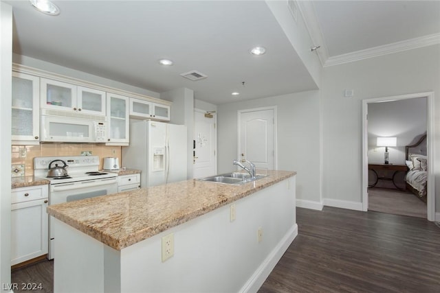 30 Strada Di Villaggio 248, Henderson, NV 89011 - kitchen with backsplash, dark hardwood / wood-style flooring, white appliances, and a center island with sink