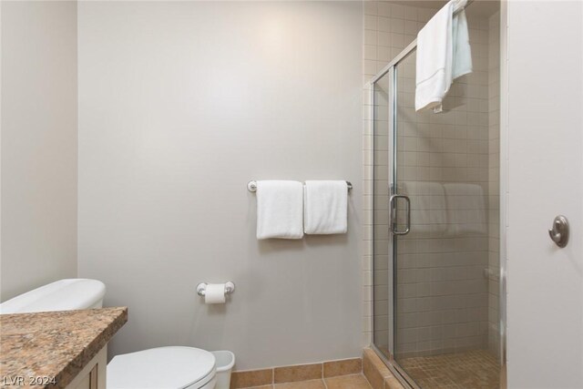 30 Strada Di Villaggio 248, Henderson, NV 89011 - bathroom featuring vanity, toilet, a shower with door, and tile patterned flooring