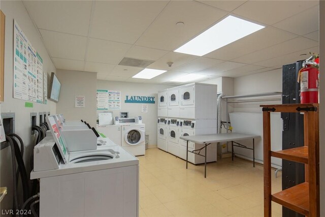 30 Strada Di Villaggio 248, Henderson, NV 89011 - laundry room featuring stacked washer and clothes dryer, washing machine and dryer, and light tile patterned floors