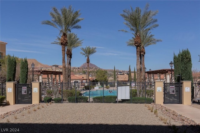 surrounding community featuring a pool and a mountain view