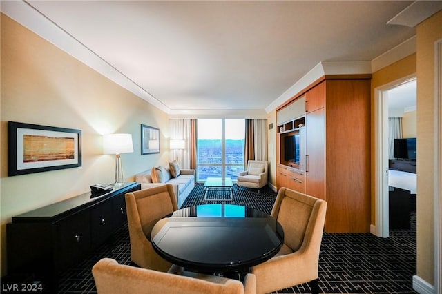 living room featuring floor to ceiling windows and dark carpet