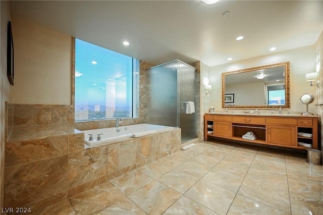 bathroom with vanity and independent shower and bath