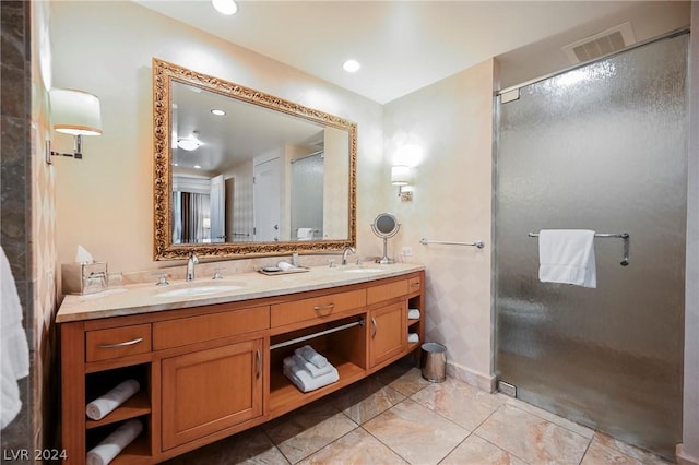 bathroom featuring vanity and a shower with door