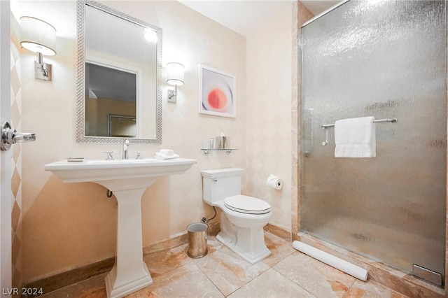 bathroom featuring toilet and an enclosed shower