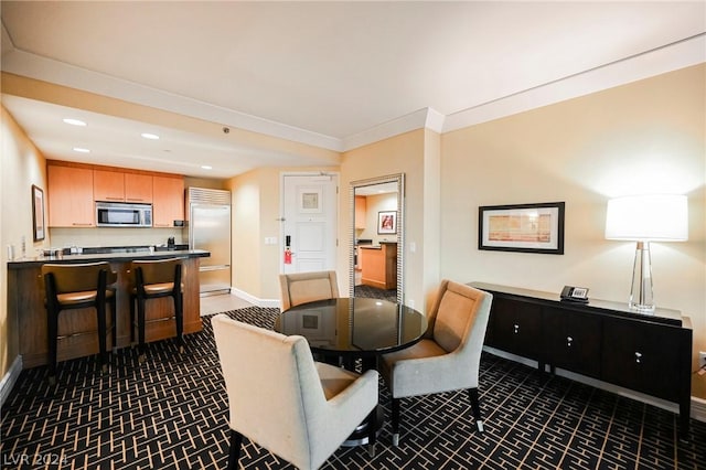 dining area featuring crown molding