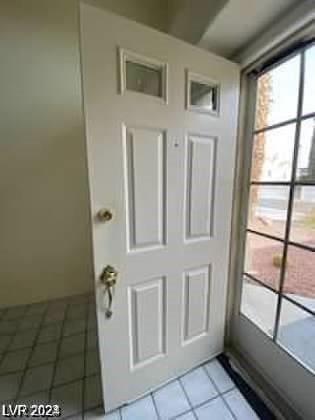 doorway featuring light tile patterned floors