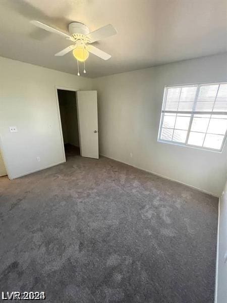 unfurnished room featuring ceiling fan and carpet flooring