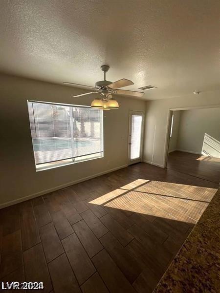 spare room with ceiling fan and a textured ceiling