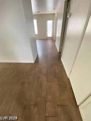 hallway with dark hardwood / wood-style floors