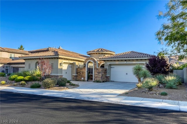 mediterranean / spanish-style home featuring a garage