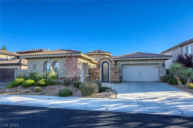 mediterranean / spanish house featuring a garage