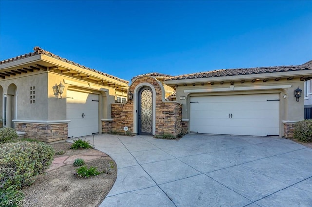 mediterranean / spanish-style home with a garage