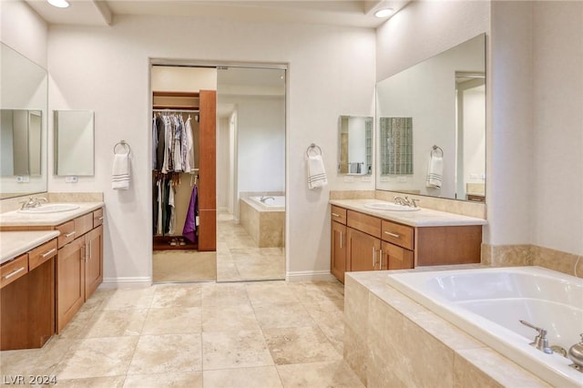 bathroom with vanity and tiled bath