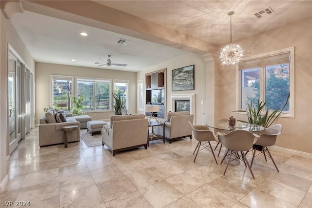 dining room with ceiling fan with notable chandelier