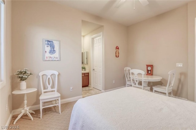 carpeted bedroom with ceiling fan and ensuite bathroom