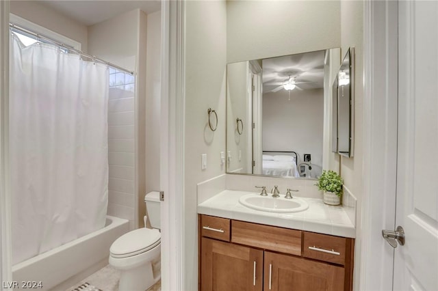 full bathroom featuring shower / bath combo, vanity, toilet, and ceiling fan