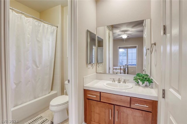 full bathroom with vanity, toilet, ceiling fan, and shower / bath combo with shower curtain