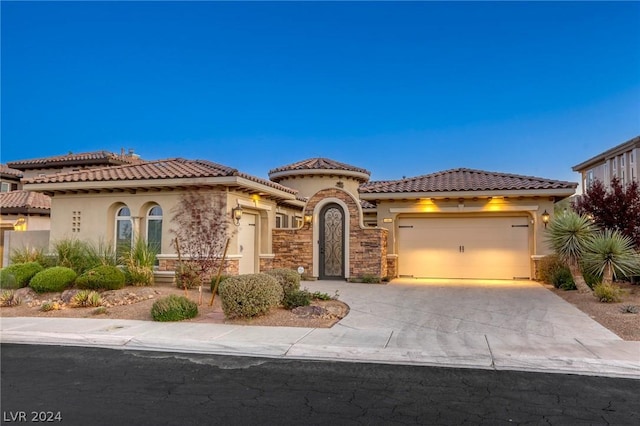 mediterranean / spanish-style house with a garage