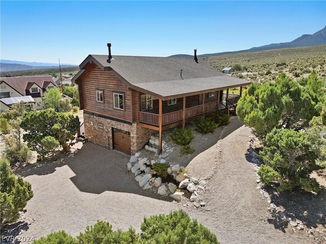 back of house featuring a mountain view and a garage