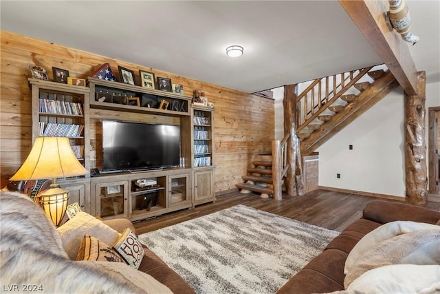 living room with dark hardwood / wood-style flooring, beamed ceiling, and wood walls