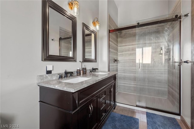 bathroom with vanity and a shower with door