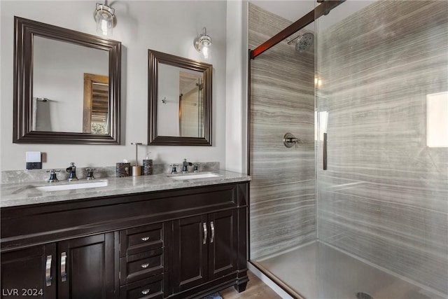 bathroom featuring an enclosed shower and vanity