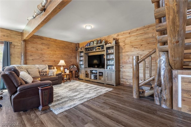 living room featuring wood walls, dark hardwood / wood-style floors, and beamed ceiling