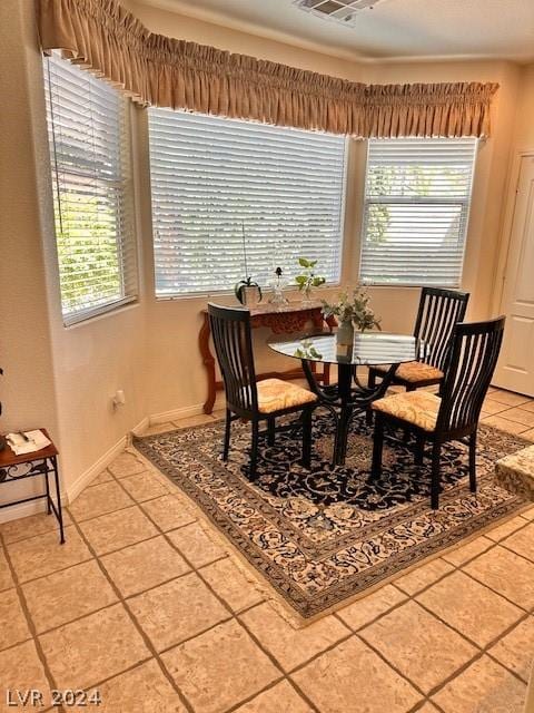 dining space with plenty of natural light and tile patterned floors