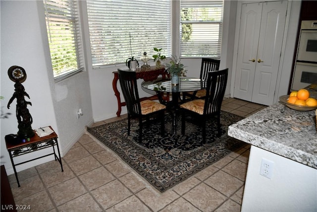 tiled dining room featuring a wealth of natural light