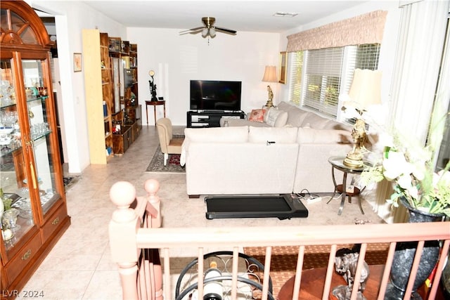 tiled living room with ceiling fan