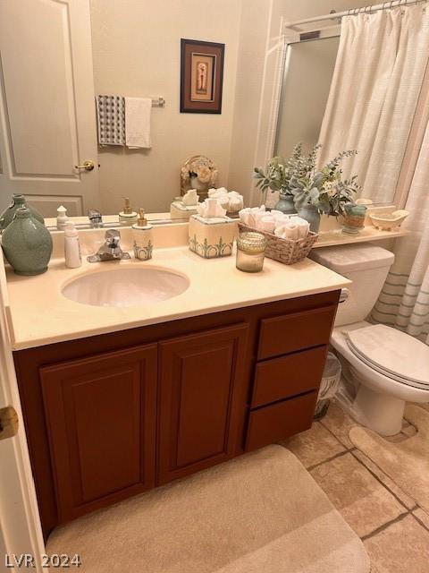 bathroom featuring vanity, toilet, and a shower with shower curtain