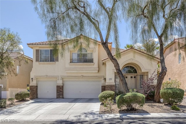 3179 Surf Spray St, Las Vegas, NV 89117 - mediterranean / spanish home featuring an attached garage, stucco siding, concrete driveway, a tile roof, and stone siding
