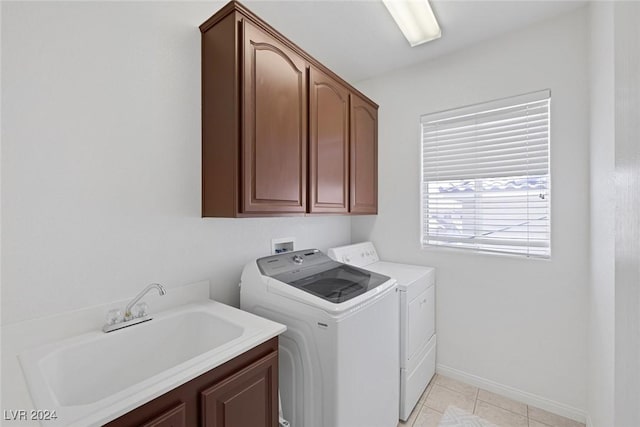 3179 Surf Spray St, Las Vegas, NV 89117 - laundry room featuring washer and clothes dryer, cabinet space, baseboards, and light tile patterned flooring