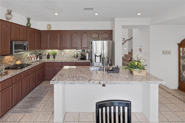 3179 Surf Spray St, Las Vegas, NV 89117 - kitchen with stainless steel appliances, a sink, decorative backsplash, light stone countertops, and recessed lighting