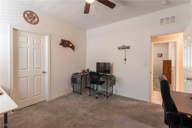 carpeted office space featuring ceiling fan