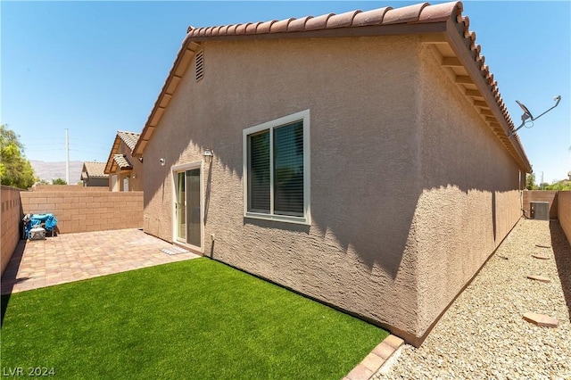 back of house with a patio area and central air condition unit