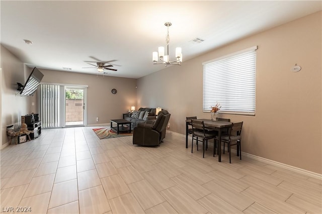 living room featuring ceiling fan with notable chandelier