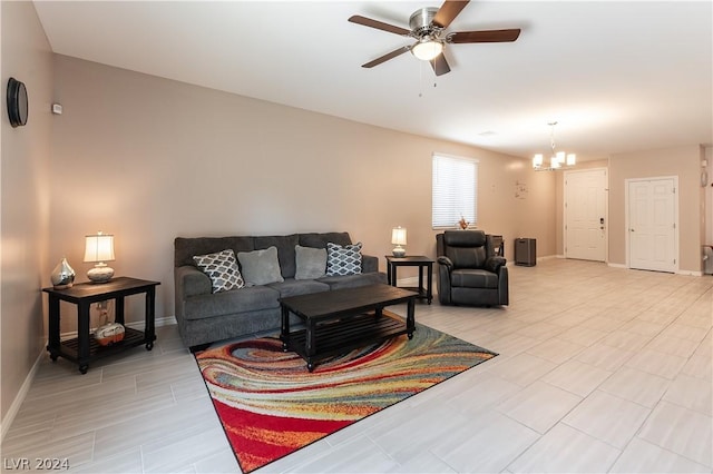 living room featuring ceiling fan with notable chandelier