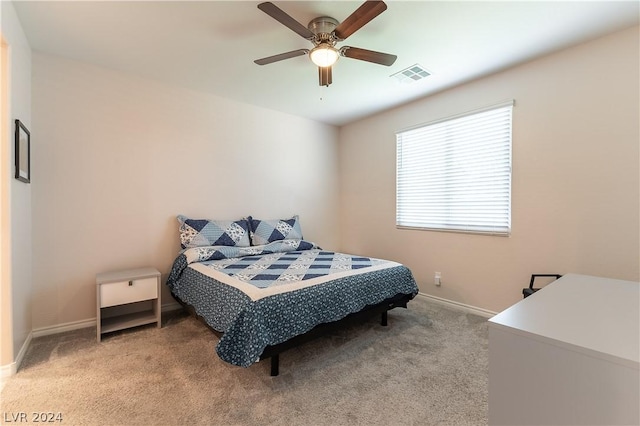 bedroom featuring light colored carpet and ceiling fan