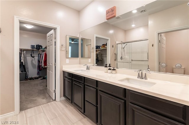 bathroom with vanity and a shower with door